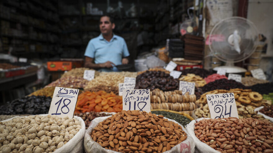 A nuts vendor at the Machane Yehuda open-air market in Jerusalem on a summer afternoon, on July 27, 2016. Photo by Nati Shohat/Flash90.