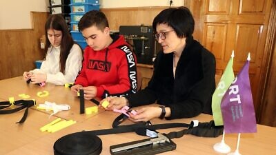 Students from ORT’s Chernivtsi Jewish School work together to design and produce much-needed tourniquets for victims of military attacks. Credit: ORT.
