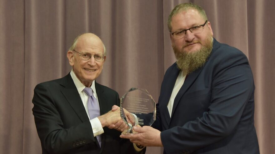 Stuart E. Eizenstat, chairman of the United States Holocaust Memorial Council, presents historian Piotr Cywiński, director of the Auschwitz-Birkenau State Museum, with the National Leadership Award on the site’s 75th year, July 13, 2022. Photo by Photo by Łukasz Lipiński.