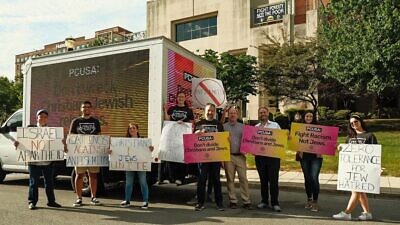 Participants in the “Sidewalk Stand Against Antisemitism” hold signs in front of a mobile billboard reading “Don’t Wreck Jewish-Christian relations” near the Presbyterian Church (U.S.A.) headquarters in Louisville, Ky., June 28, 2022. Credit: Courtesy of the Philos Action League and Pathways for Peace.