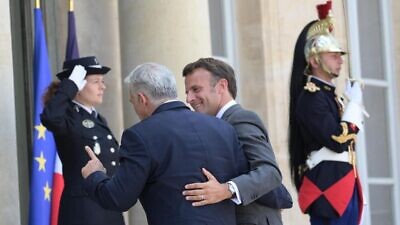 French President Emmanuel Macron welcomes Israeli Prime Minister Yair Lapid to the Élysée Palace in Paris on July 5, 2022. Credit: Amos Ben-Gershom/GPO.