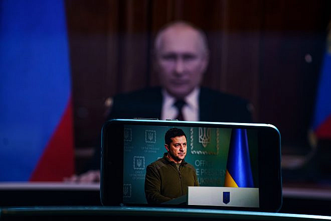 Ukrainian President Volodymyr Zelenskyy on TV with Russian President Vladimir Putin in the background, March 7, 2022. Credit: Rokas Tenys/Shutterstock.