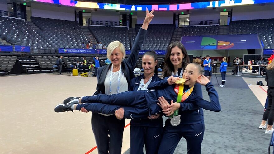 Daria Atamanov (being held) celebrates her medals in rhythmic gymnastics. Photo by Larry Brook.