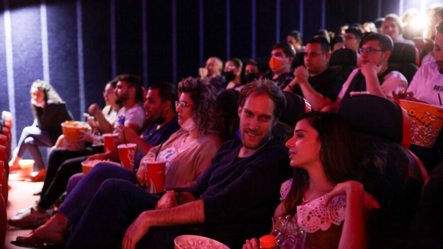 Israelis attend a movie at the Cinema City theater on the official reopening night after 14 months of closure during the coronavirus pandemic, on May 27, 2021 in Jerusalem. Photo by Olivier Fitoussi/Flash90.