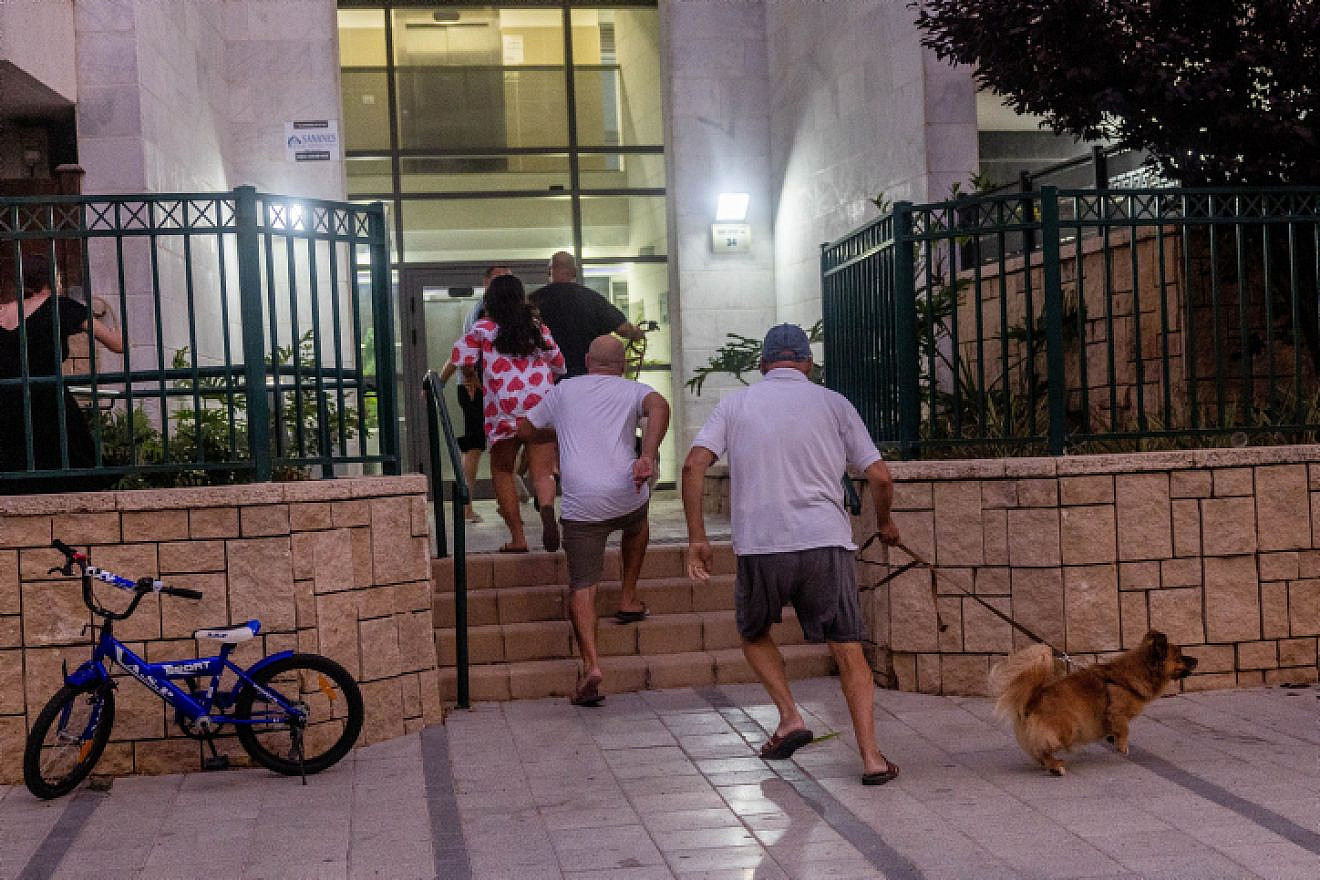 Residents of the southern Israeli city of Ashkelon run for shelter during a Palestinian Islamic Jihad rocket attack on Aug. 6, 2022. Photo by Yonatan Sindel/Flash90.
