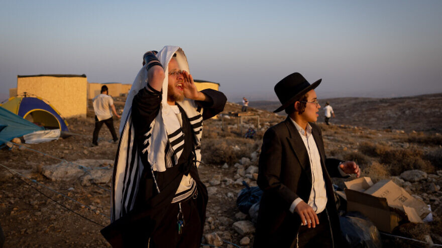 Ultra-Orthodox, or haredi, Jewish men at the Derech Emunah outpost in Judea and Samaria, on Aug.16, 2022. Photo by Yonatan Sindel/Flash90.
