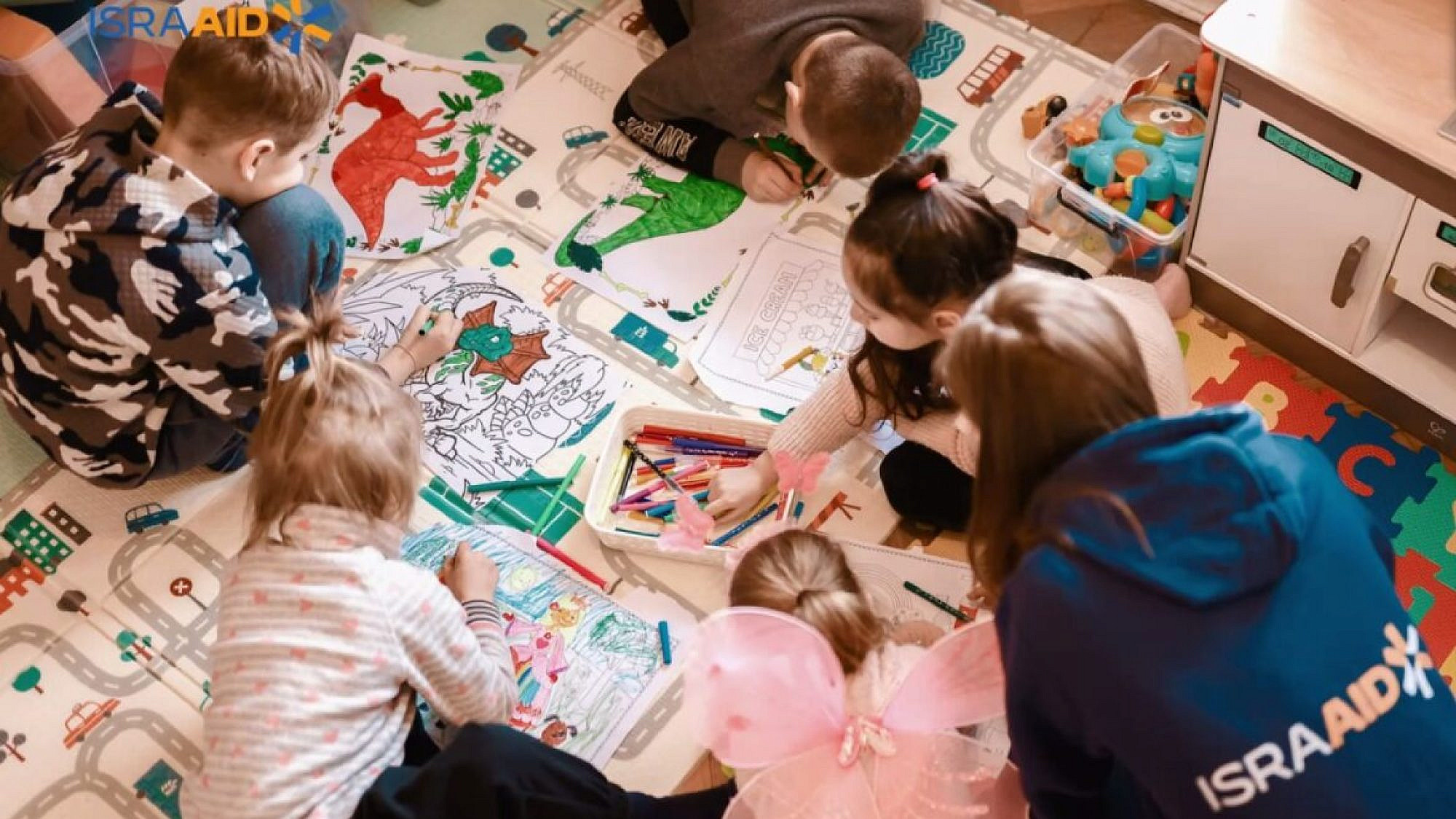 Ukrainian refugee children enjoying activities in an IsraAID community center. Source: Screenshot
