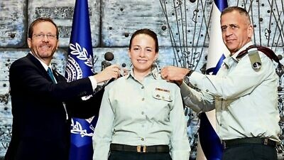 Israel's President Isaac Herzog (left) and IDF Chief of Staff Lt. Gen. Aviv Kochavi award Naama Rosen the rank of brigadier general as she is appointed first female military secretary to the Israeli president at the President's Residence in Jerusalem on July 31, 2022. Credit: Haim Zach/GPO.