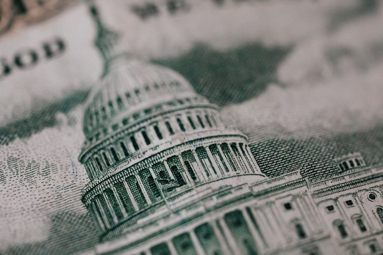 U.S. Capitol building in backdrop of American money. Credit: Karolina Grabowska via Pexels.