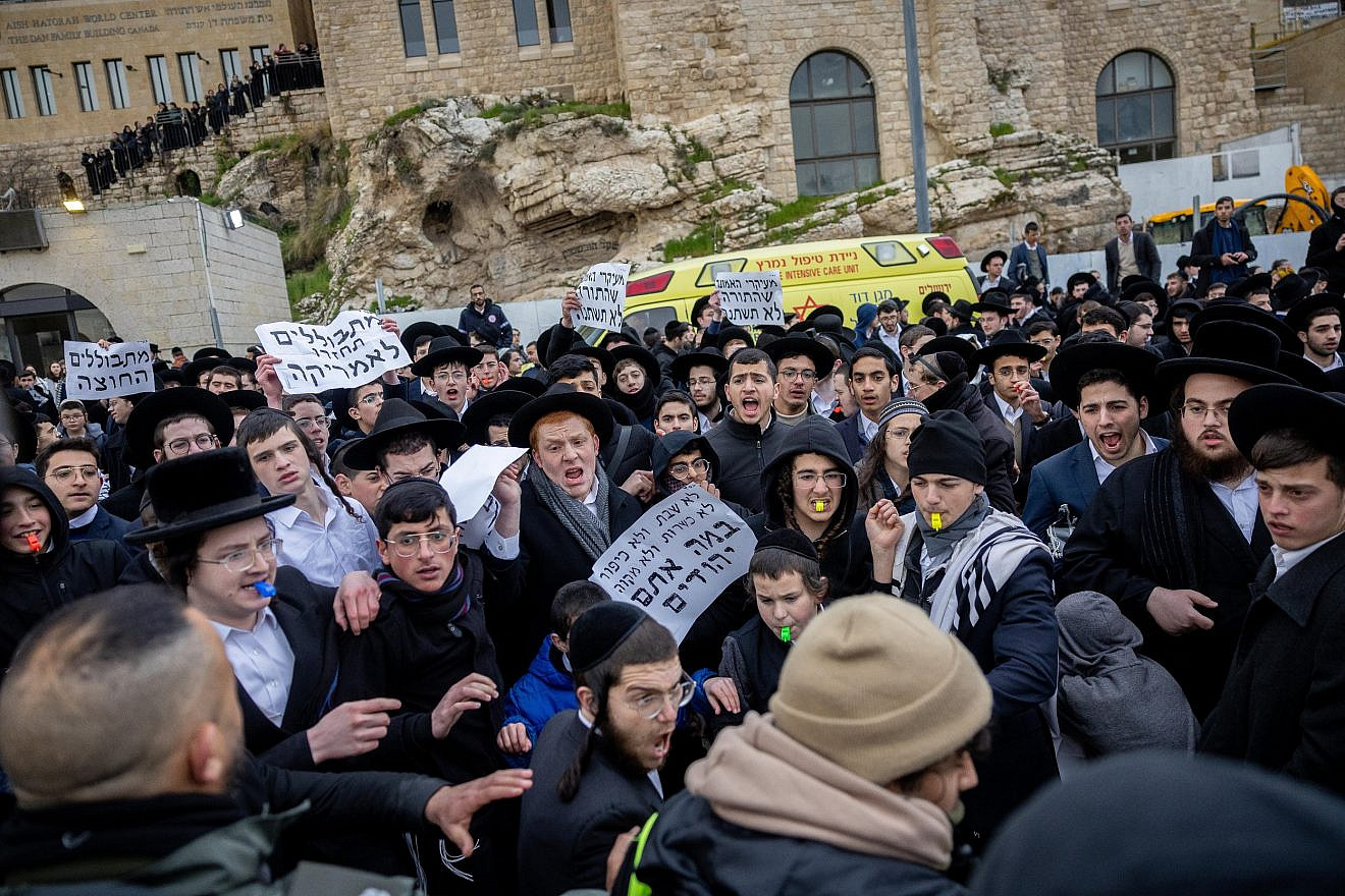 Haredi Jews scuffle with police as they protest members of the Women of the Wall movement bringing in Torah scrolls to hold Rosh Chodesh prayers at the Western Wall in Jerusalem on March 4, 2022. Photo by Yonatan Sindel/Flash90.