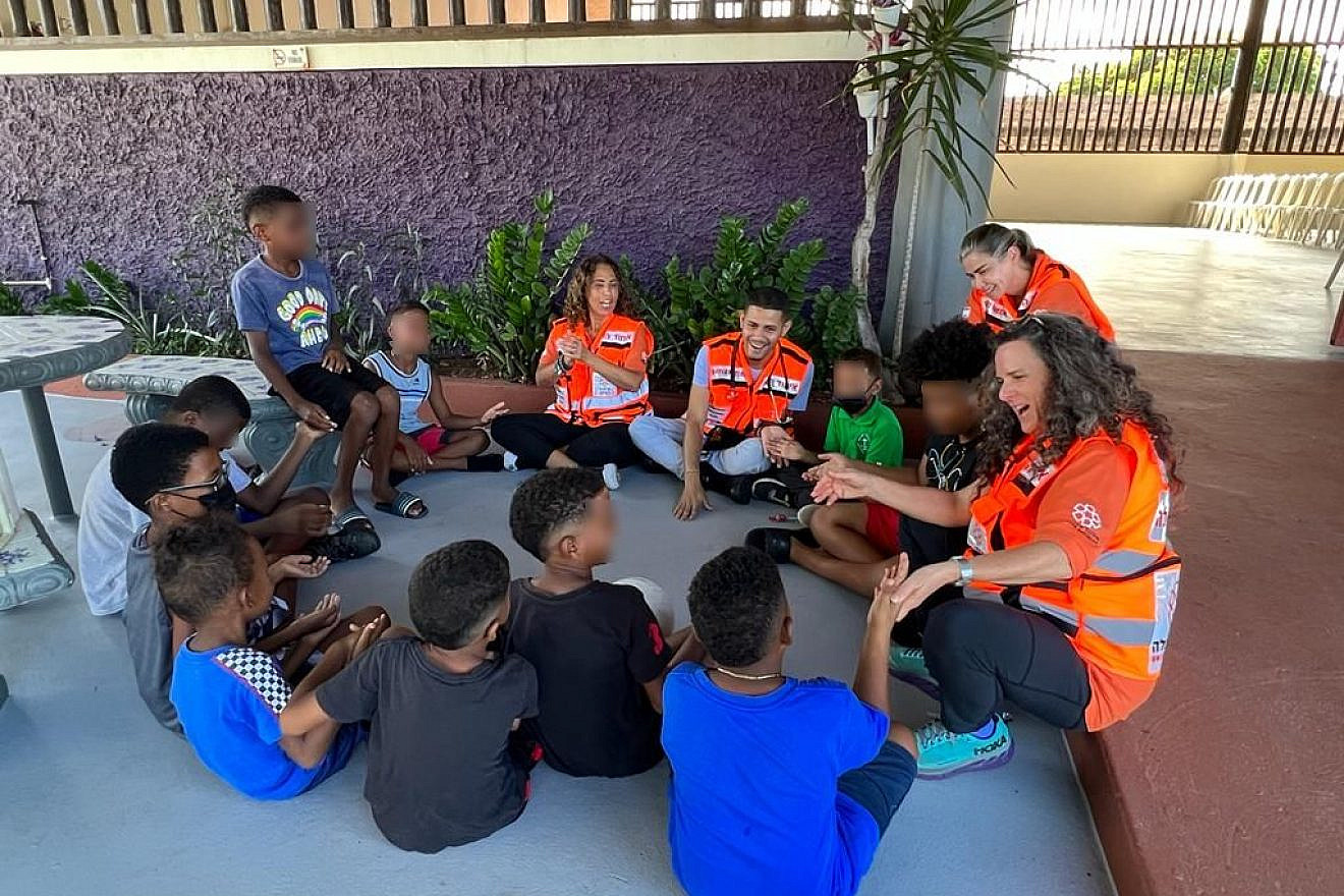 Dr. Tamar Shlezinger and Dr. Kamila Forkosh Lavan with local medical student Luis Vasquez and Israeli social worker Gabriella Rourka working with children at a shelter in Loiza, Puerto Rico. Photo: United Hatzalah