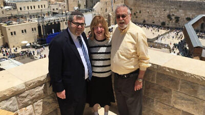 Rabbi Melvin I. Burg stands above the Western Wall Plaza in Jerusalem along with his wife, Pearl, and son Rabbi Steven Burg. Credit: Aish Global.