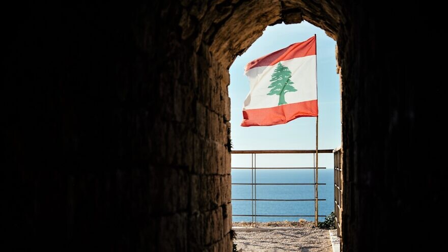 Lebanese flag at the country's Byblos fortress overlooking the Mediterranean Sea. Credit: Yulia Grigoryeva/Shutterstock.
