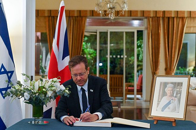 Israeli President Isaac Herzog signs the condolence book for Queen Elizabeth II at the residence of the British ambassador to Israel in Ramat Gan on September 10, 2022. Credit: Koby Gideon/GPO.