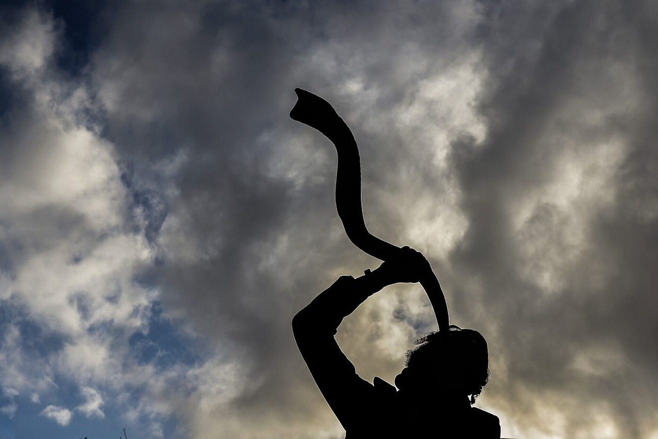 A Jewish man blows a shofar horn in Meron in northern Israel, on Dec. 1, 2021. Photo by David Cohen/Flash90.