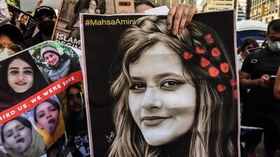 A protester holds a picture of Mahsa Amini, the Kurdish woman whose death in the custody of Iran's "morality police" has sparked widespread unrest. Credit: Twitter.