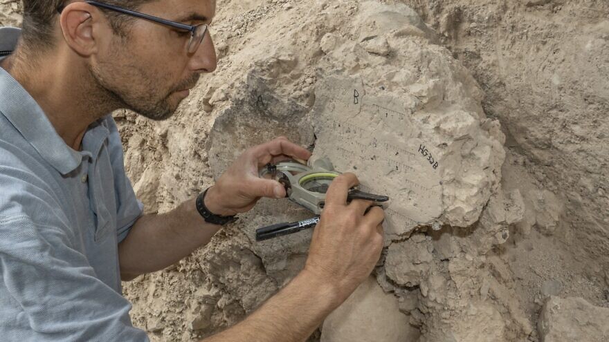 A researchers takes measurements at an archaeological site in Israel. Credit: Tel Aviv University.