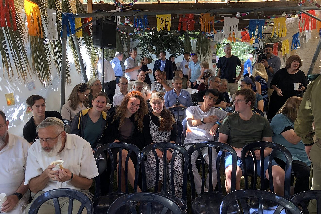 Efrat residents gather in the city's Sukkah of Peace, October 16, 2022. Credit: Josh Hasten.