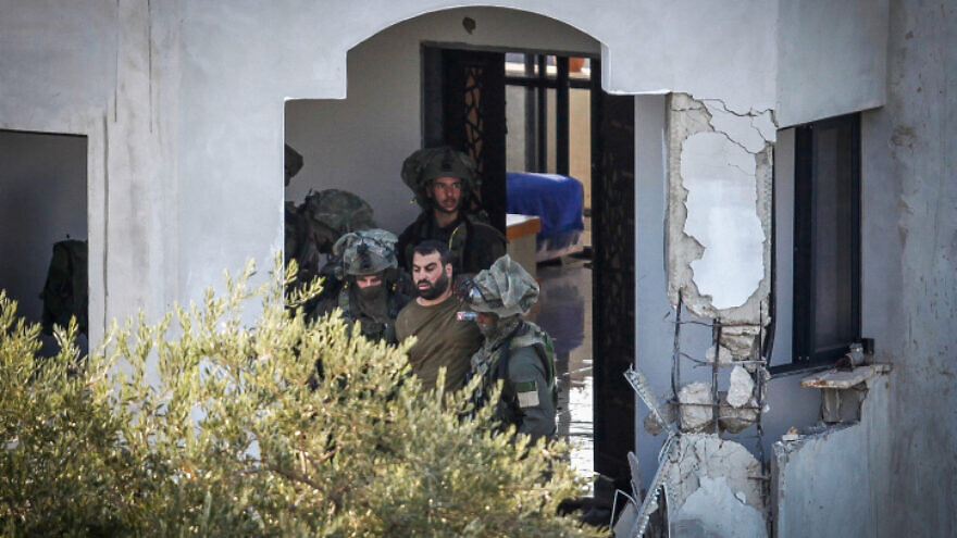 Israeli security forces arrest a Palestinian gunman during a raid on a building in the village of Deir al-Hatab, near Nablus, Oct. 5, 2022. Photo by Nasser Ishtayeh/Flash90.