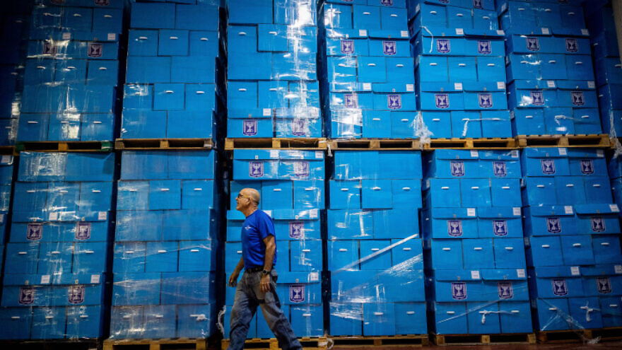 Workers prepare ballot boxes for the upcoming Israeli elections, at the central elections committee warehouse in Shoham, before they are shipped to polling stations, Oct. 12, 2022. Photo by Yonatan Sindel/Flash90.