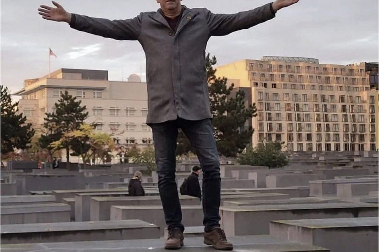 AfD politician Holger Winterstein on one of the 2,711 stone slabs at the Holocaust Memorial in Berlin, Oct. 8, 2022. Source: Twitter.