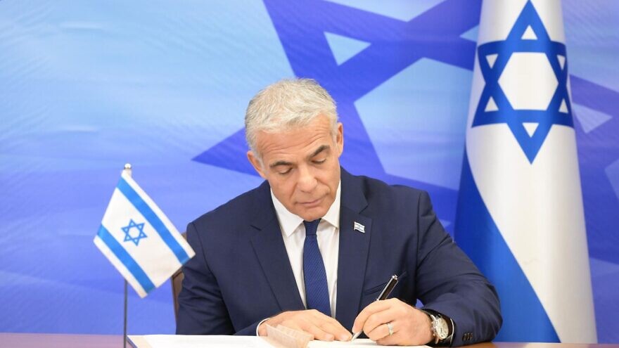 Israeli Prime Minister Yair Lapid signs the U.S.-mediated maritime border and natural gas deal with Lebanon, October 27, 2022. Credit: Amos Ben-Gershom/GPO.