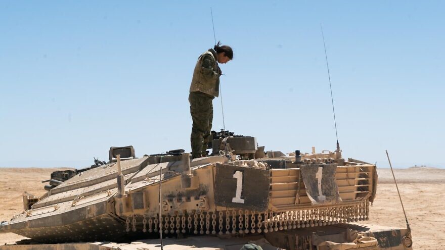 In this image, published by the Israel Defense Forces on Oct. 26, an IDF soldier can be seen standing atop a Merkava tank in southern Israel. Credit: IDF.