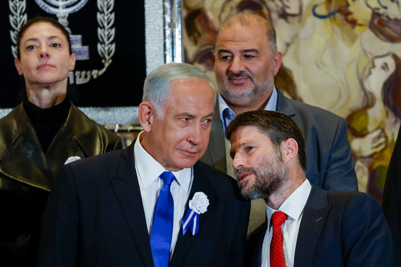Likud leader Benjamin Netanyahu speaks with Religious Zionism Party head Bezalel Smotrich at the swearing-in of the 25th Knesset in Jerusalem, Nov. 15, 2022. Photo by Olivier Fitoussi/Flash90.