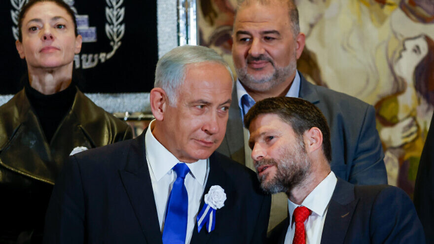 Likud leader Benjamin Netanyahu speaks with Religious Zionist Party head MK Bezalel Smotrich at the swearing-in of the 25th Knesset, at the Israeli parliament in Jerusalem, Nov. 15, 2022. Photo by Olivier Fitoussi/Flash90.