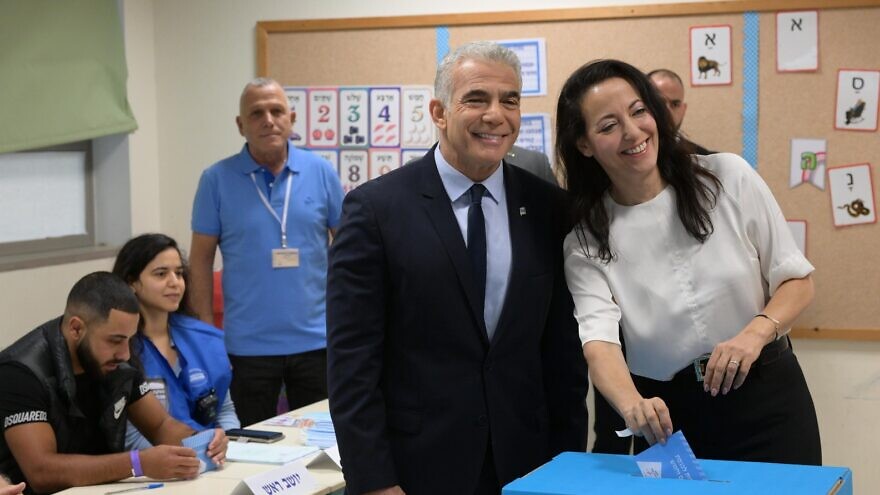 Israeli Prime Minister Yair Lapid and his wife Lihi vote in Israel's national election, Nov. 1, 2022. Credit: Amos Ben Gershom/GPO.