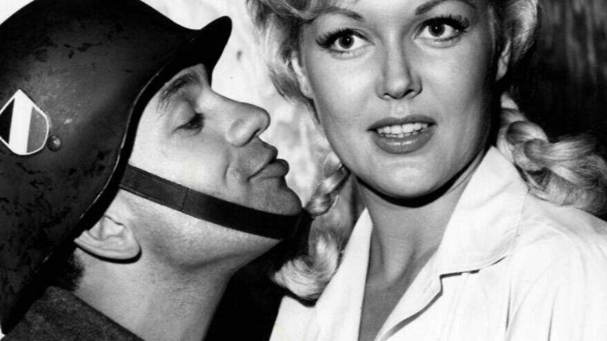 Robert Clary as Lebeau and Cynthia Lynn as Fräulein Helga from the television program "Hogan's Heroes," 1965. Source: Wikimedia Commons.