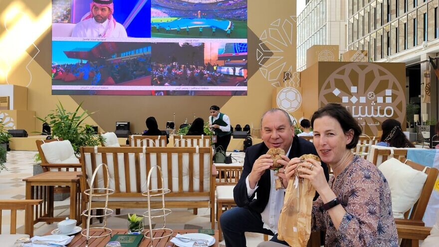 Rabbi Marc Schneier, president of the Foundation for Ethnic Understanding (FFEU), and Iris Ambor,  head of the Israeli Foreign Ministry delegation to Doha, enjoy a kosher bagel sandwich at the FIFA World Cup in Qatar. Courtesy: FFEU.