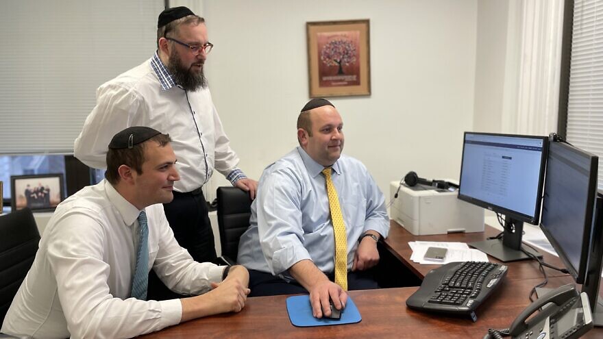 Left to right: Yachad’s Michael Appelbaum, assistant director of communal engagement, Avrumy Jordan, director of marketing, and Avromie Adler, international director, review Yachad REACH’s vast database