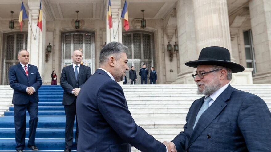 Marcel Ciolacu, president of the Chamber of Deputies, greets Rabbi Pinchas Goldschmidt, president of the Conference of European Rabbis, at the Palace of Parliament in Bucharest, Nov.15, 2022. Photo by Eli Itkin.
