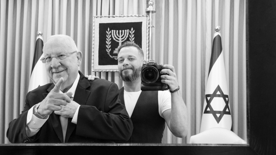 Israeli combat veteran and photographer Lior Nir poses with former Israeli President Reuven Rivlin as part of a pop-up exhibition showing this weekend in New York City to raise awareness of Israeli vets dealing with PTSD. Credit: Mike Wagenheim.