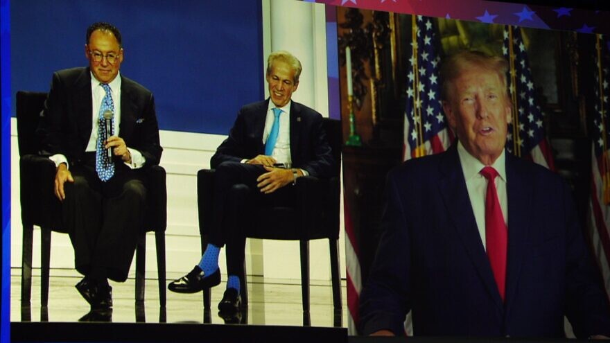 Republican Jewish Coalition CEO Matt Brooks (L) and National Chairman Sen. Norm Coleman (C) speak with former U.S. President Donald Trump, who appeared via satellite at the RJC's annual meetings, November 19, 2022. Credit: Republican Jewish Coalition.