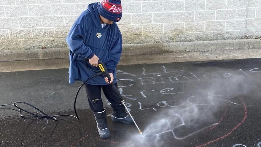 Residents of Loudoun County clean up antisemitic and racist messages that were spray-painted in the South Riding area of the county. Credit: Facebook.