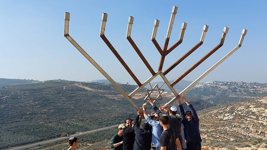 A delegation from Great Neck, NY joins local youth to raise a large Hanukkah menorah over the Shiloh valley, on December 9, 2022. Photo courtesy of the Heartland Initiative.
