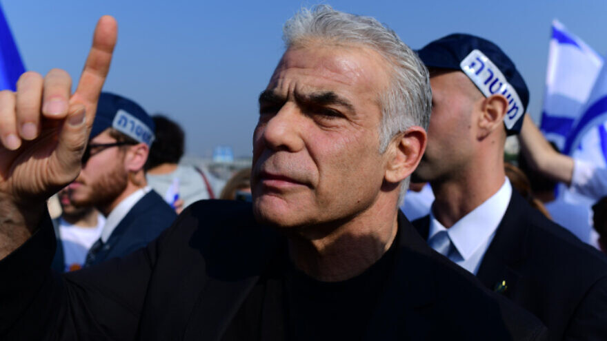 Outgoing Prime Minister Yair Lapid and Yesh Atid Party activists protest in Tel Aviv against Benjamin Netanyahu's incoming government, Dec. 9, 2022. Photo by Tomer Neuberg/Flash90.