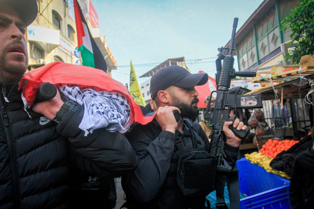 Palestinian gunmen and mourners participate in the funeral procession of 16-year-old Jana Zakarneh, killed the previous night during an IDF raid in Jenin, Dec. 12, 2022. Photo by Nasser Ishtayeh/Flash90.