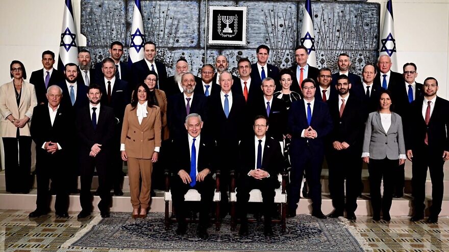 President Isaac Herzog and Prime Minister Benjamin Netanyahu sit at the center of the traditional photograph of the incoming government at the President's Residence in Jerusalem, Dec. 29, 2022. Credit: Avi Ohayon/GPO.