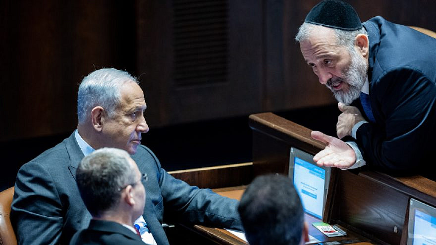 Prime Minister Benjamin Netanyahu speaks with Shas Chairman Aryeh Deri in the Knesset. Photo by Yonatan Sindel/Flash90.