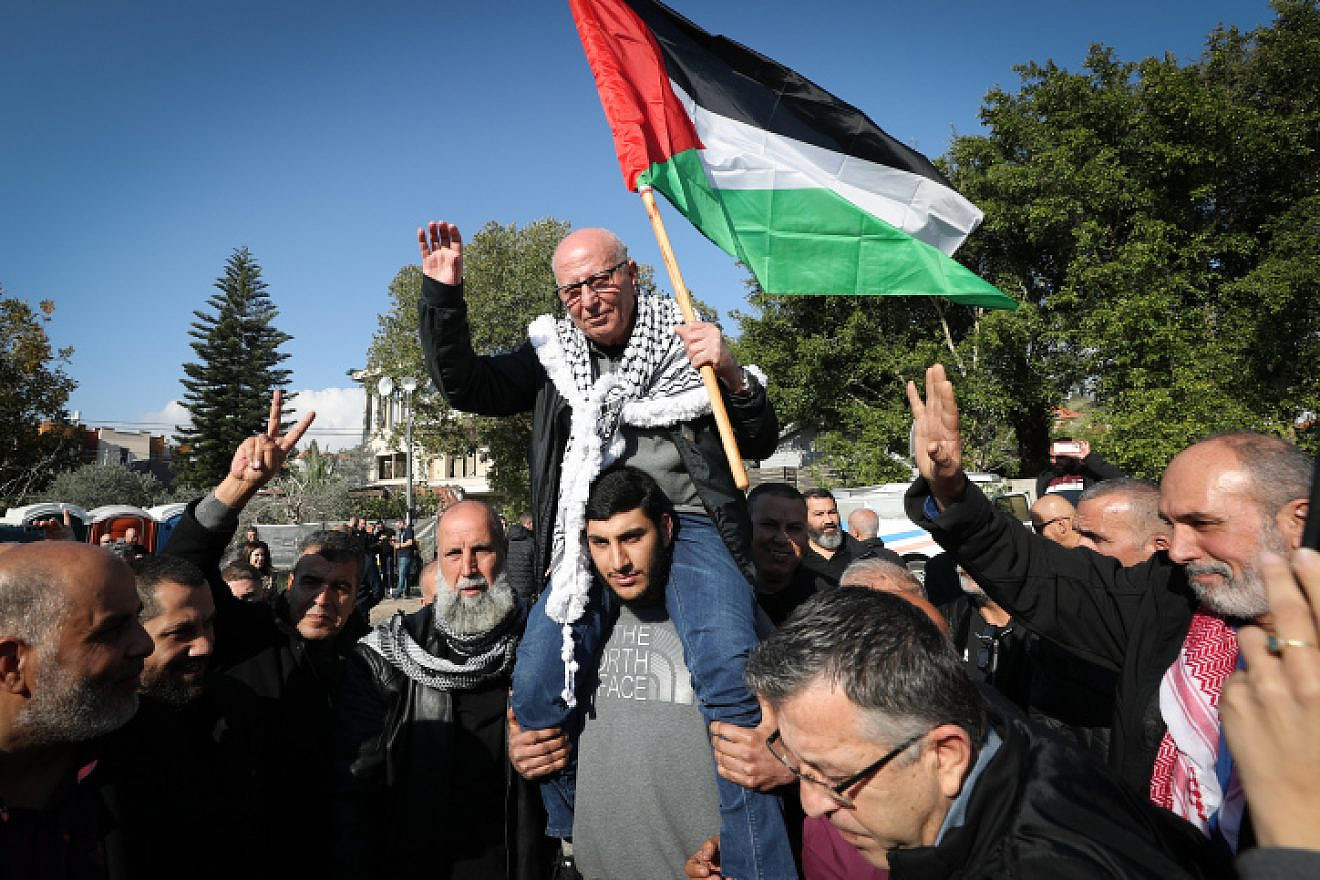 Palestinian flags flew as family and friends greeted Karim Younis, released after 40 years for murdering an IDF soldier, at Ar'ara, Jan. 5, 2023. Photo by Jamal Awad/Flash90.