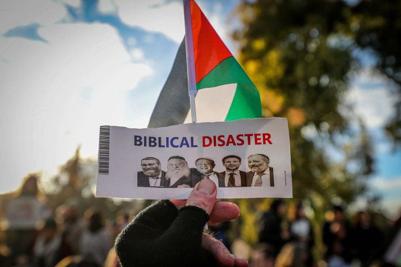 Palestinians protest against the evacuation of squatters from the eastern Jerusalem neighborhood of Sheikh Jarrah with a sign denigrating Jewish history and the Israeli government, Jan. 13, 2023. Photo by Jamal Awad/Flash90.