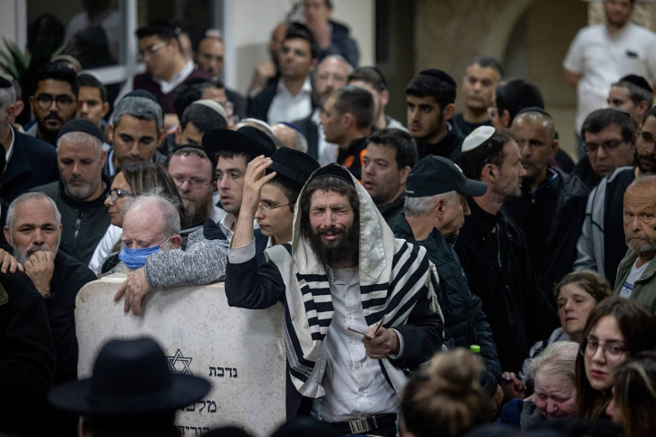 Mourners attend the funeral at the Beit Shemesh Cemetery for Eli and Natalie Mizrahi, who were murdered in the shooting attack in Jerusalem's Neve Ya'akov neighborhood on Friday, Jan. 28, 2023. Photo by Yonatan Sindel/Flash90.
