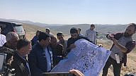 MKs Yuli Edelstein (left) and Danny Danon (second from left) study a map during a fact-finding visit to the illegal Bedouin encampment of Khan al-Ahmar near Jerusalem, Jan 23, 2023. Photo by Josh Hasten.