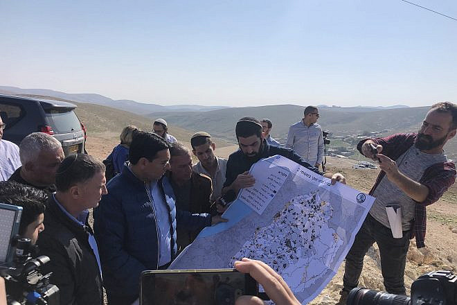 MKs Yuli Edelstein (left) and Danny Danon (second from left) study a map during a fact-finding visit to the illegal Bedouin encampment of Khan al-Ahmar near Jerusalem, Jan 23, 2023. Photo by Josh Hasten.