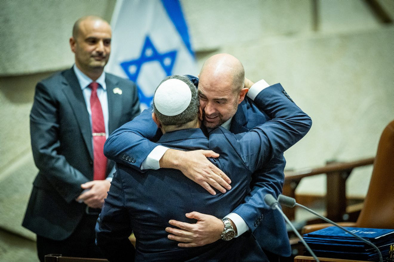 Knesset Speaker Amir Ohana (facing the camera) and Minister of National Security Itamar Ben-Gvir embrace at the swearing-in ceremony for the Netanyahu government at the Knesset in Jerusalem, Dec. 29, 2022. Photo by Yonatan Sindel/Flash90.