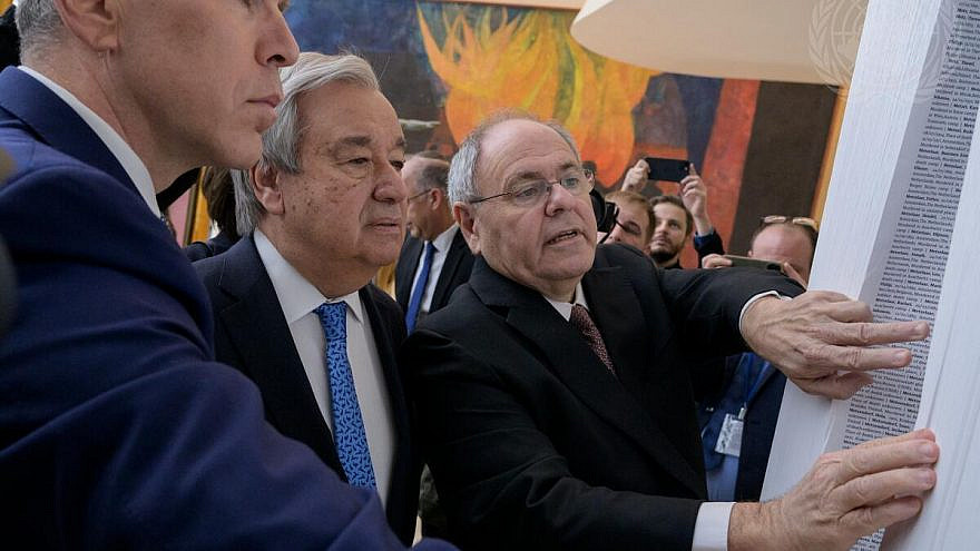 U.N. Secretary-General António Guterres (center); Gilad Erdan (left), Israel's ambassador to the United Nations; and Dani Dayan, Yad Vashem chair, at the exhibit “The Yad Vashem Book of Names of Holocaust Victims.”/UN