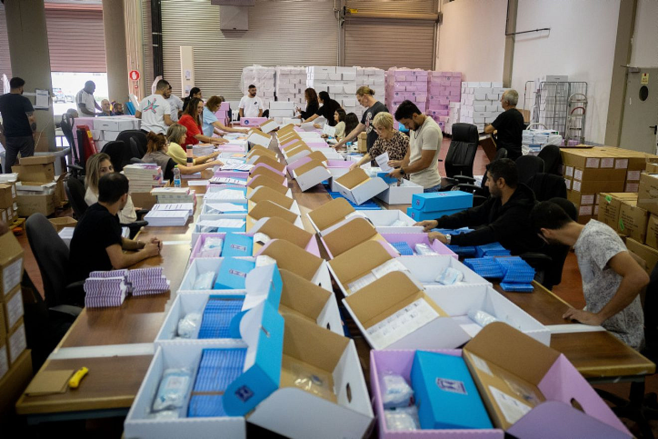 Workers prepare ballot boxes for Israel's Nov. 1 election, at the Central Elections Committee warehouse in Shoham, before they were shipped to polling stations, Oct.12, 2022. Photo by Yonatan Sindel/Flash90.